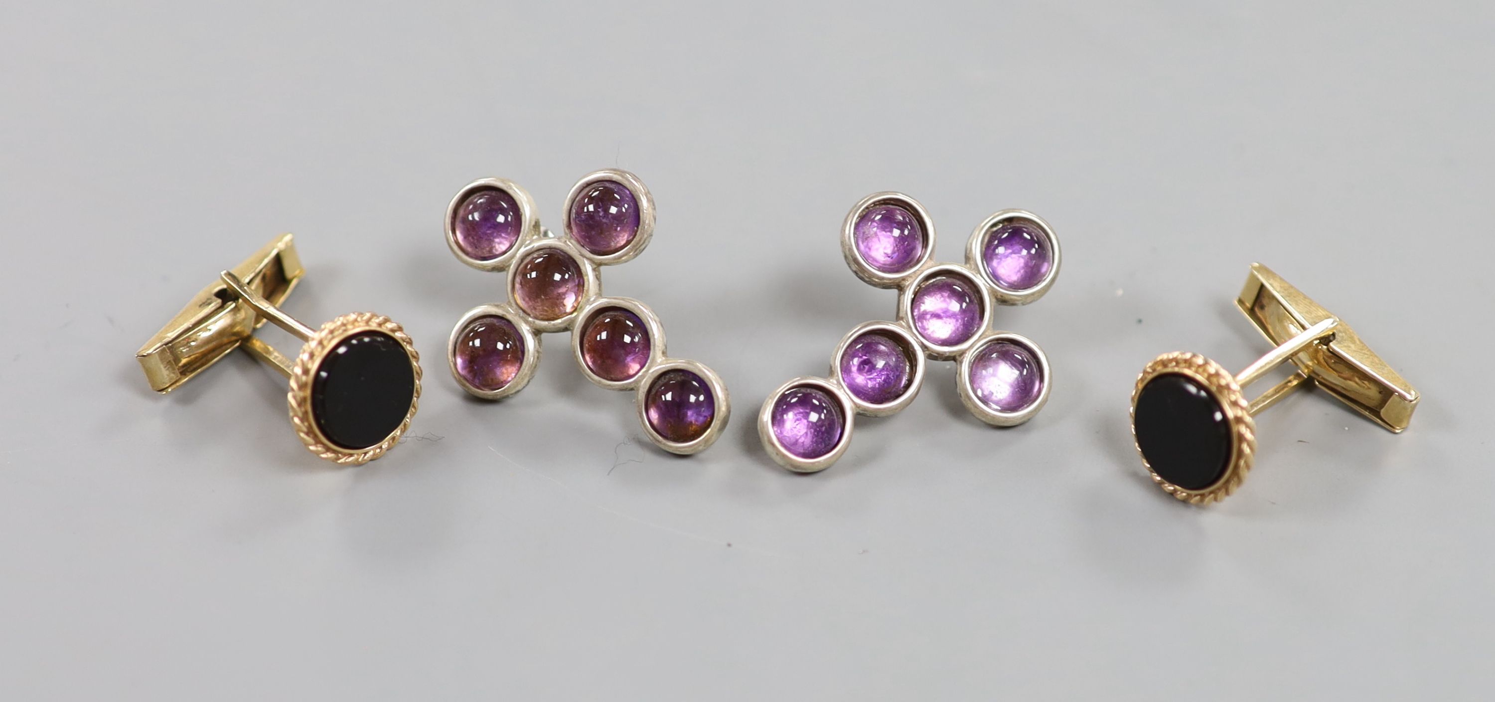 A pair of modern 9ct gold and black onyx set circular cufflinks, diameter 13mm, gross 6.7 grams and a pair of silver and cabochon amethyst set cross ear studs (one butterfly missing).